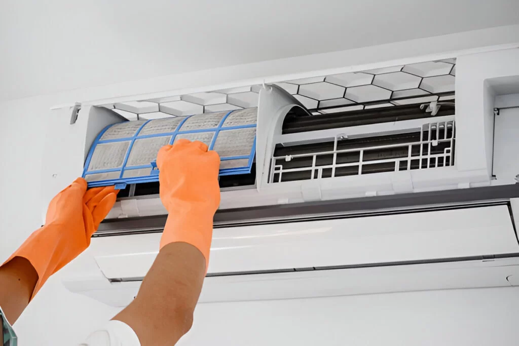 Dusty AC filter being removed, why regular cleaning matters