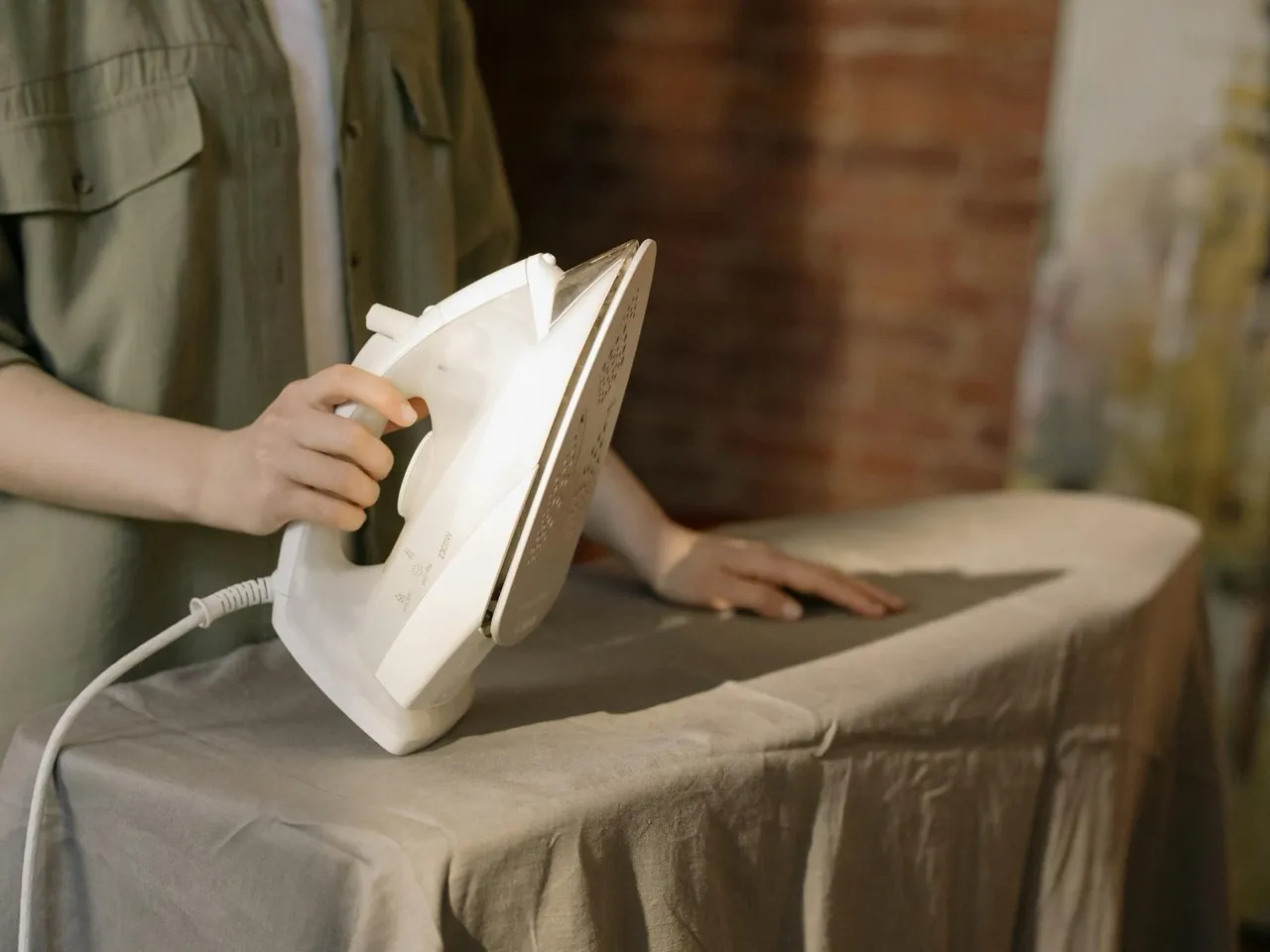 Careful professional ironing of garments on an ironing board