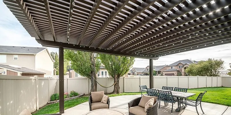 Stylish patio pergola with outdoor lounge furniture and garden backdrop